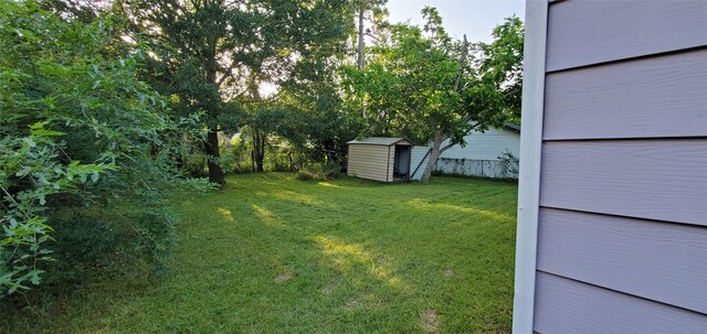 10341 Caxton St, Houston, TX 77016 - view of green lawn featuring a shed and an outdoor structure