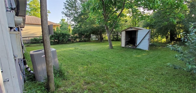 10341 Caxton St, Houston, TX 77016 - view of green lawn featuring a shed, cooling unit, and an outdoor structure