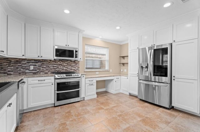 kitchen with stainless steel appliances, crown molding, white cabinetry, light stone finish floors, and tasteful backsplash