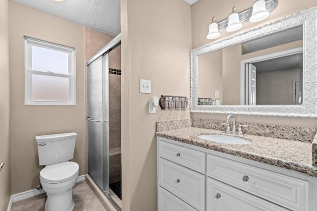 full bathroom featuring toilet, a shower stall, vanity, baseboards, and tile patterned flooring