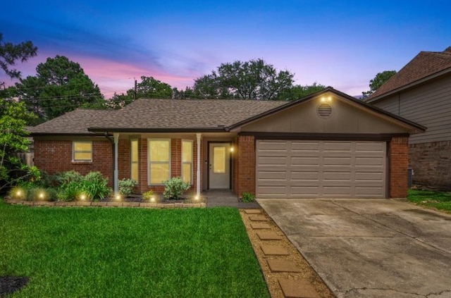 ranch-style house with concrete driveway, brick siding, an attached garage, and a lawn