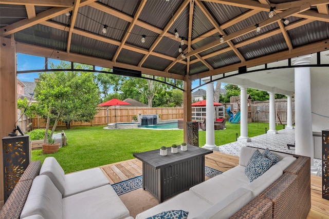 view of patio / terrace with an outdoor living space, a playground, a deck, a gazebo, and a pool with connected hot tub
