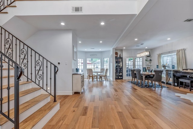 entrance foyer featuring light wood-style flooring, stairway, recessed lighting, and baseboards