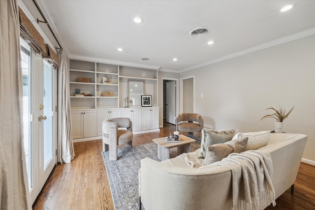 living area with ornamental molding, wood finished floors, and recessed lighting