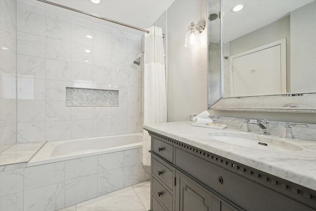 full bathroom with marble finish floors, tiled shower / bath combo, vanity, and recessed lighting
