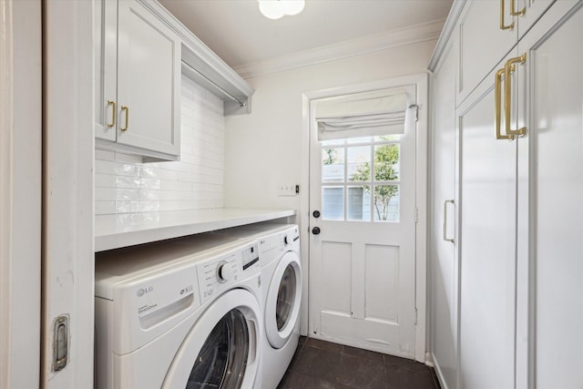 washroom with washer and clothes dryer, ornamental molding, cabinet space, and dark tile patterned flooring