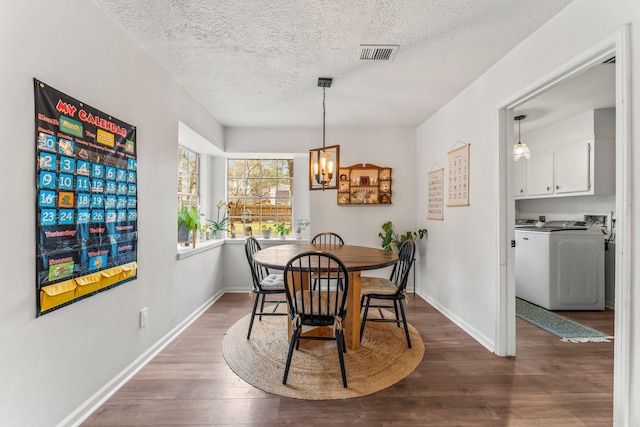 6415 Darby Way, Spring, TX 77389 - dining space featuring washer / clothes dryer, dark wood finished floors, a chandelier, a textured ceiling, and baseboards