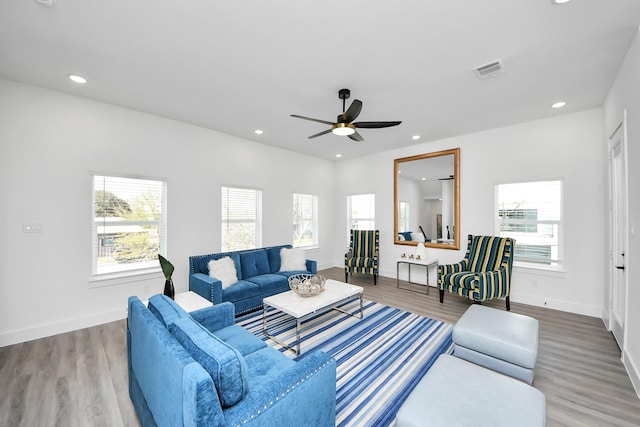 living area with ceiling fan, wood finished floors, baseboards, and recessed lighting