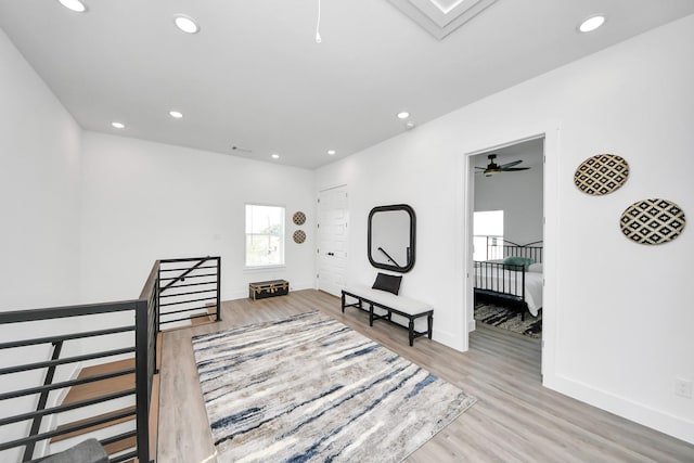 sitting room featuring an upstairs landing, wood finished floors, recessed lighting, baseboards, and a ceiling fan