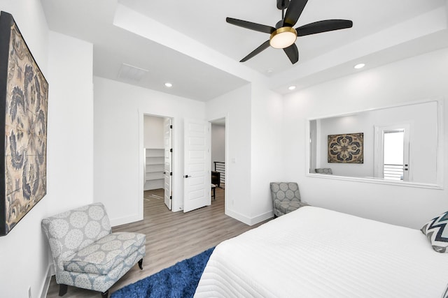 bedroom with recessed lighting, wood finished floors, baseboards, a spacious closet, and ceiling fan