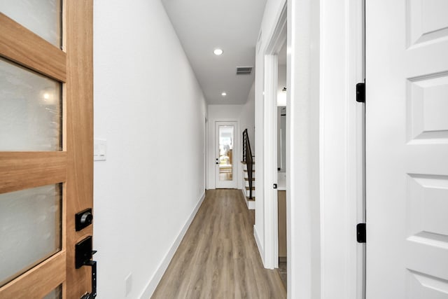 hall with light wood-type flooring, baseboards, and recessed lighting