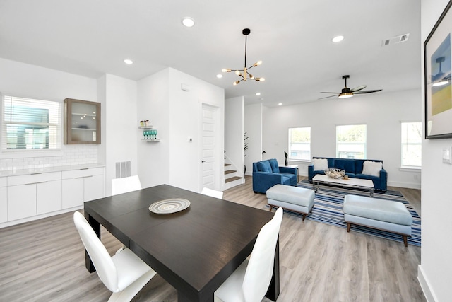 dining area featuring light wood-style floors, healthy amount of natural light, a chandelier, recessed lighting, and baseboards