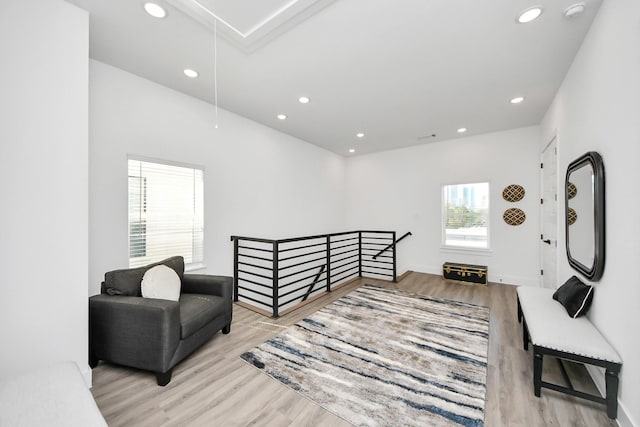 living area featuring attic access, recessed lighting, wood finished floors, and an upstairs landing