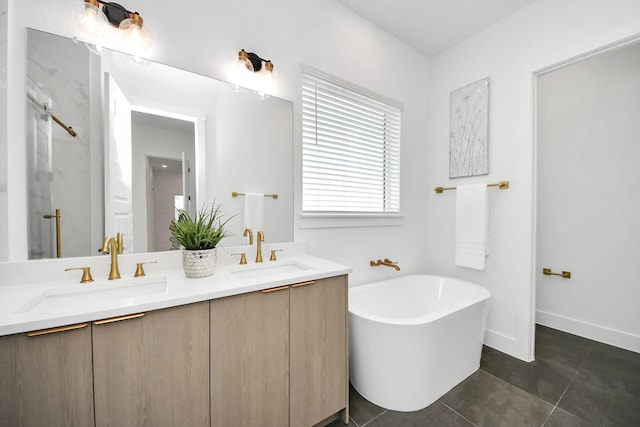 full bath with tile patterned floors, a soaking tub, double vanity, a shower, and baseboards