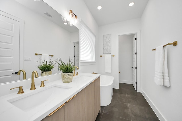 bathroom with a soaking tub, double vanity, baseboards, tile patterned floors, and recessed lighting