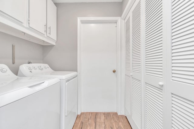 2815 Panagard Dr Unit 38, Houston, TX 77082 - clothes washing area with washing machine and clothes dryer, cabinet space, and light wood-style floors