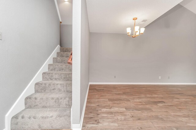 2815 Panagard Dr Unit 38, Houston, TX 77082 - stairway with wood finished floors, a chandelier, and baseboards