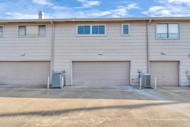 2815 Panagard Dr Unit 38, Houston, TX 77082 - rear view of property with central air condition unit, an attached garage, and a chimney