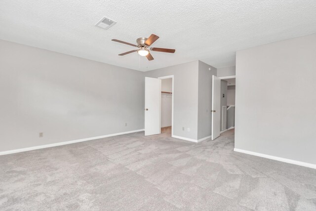 2815 Panagard Dr Unit 38, Houston, TX 77082 - unfurnished bedroom with carpet, baseboards, a textured ceiling, a ceiling fan, and a walk in closet