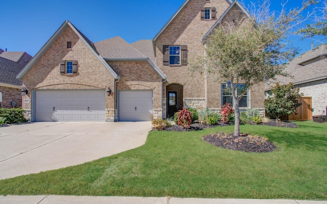 view of front of house featuring concrete driveway, a front yard, and brick siding