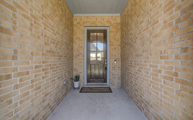 property entrance featuring brick siding