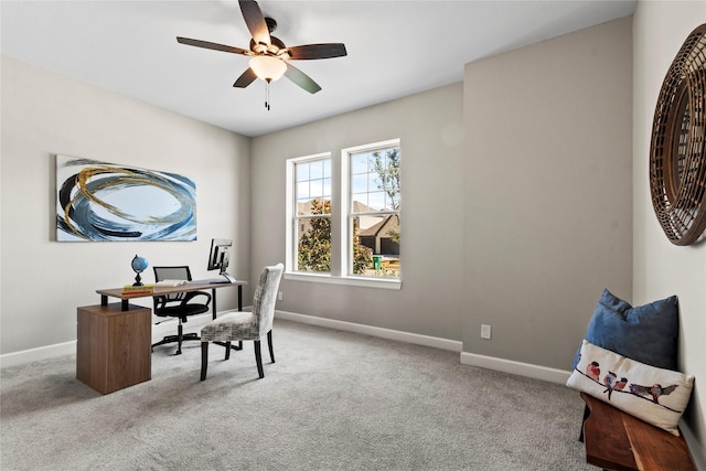 office area with carpet flooring, baseboards, and ceiling fan