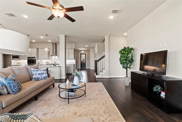 living room featuring dark wood-style floors, ceiling fan, stairs, recessed lighting, and baseboards