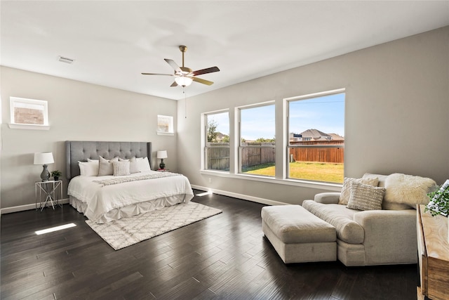 bedroom featuring baseboards, dark wood-type flooring, and ceiling fan