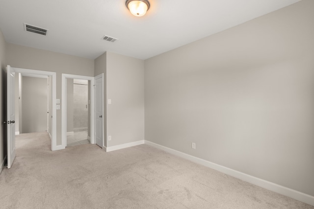 unfurnished bedroom featuring light carpet and baseboards