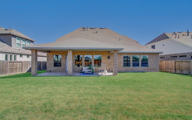 rear view of property featuring a patio area and brick siding