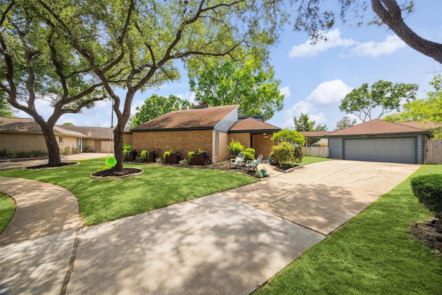 mid-century home featuring brick siding, a detached garage, and a chimney