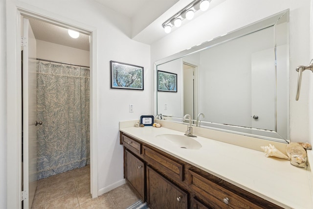 full bathroom featuring vanity, tile patterned floors, and baseboards