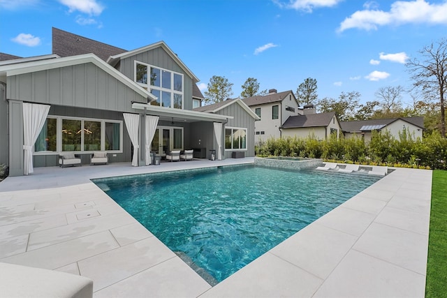 208 Heron Pointe Dr, Montgomery, TX 77316 - rear view of property featuring an outdoor hangout area, board and batten siding, a patio, ceiling fan, and a pool with connected hot tub
