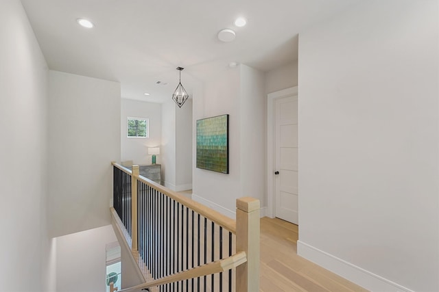 208 Heron Pointe Dr, Montgomery, TX 77316 - hall featuring an upstairs landing, light wood-style floors, recessed lighting, baseboards, and a chandelier