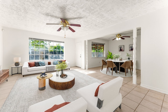 10431 Sagewillow Ln, Houston, TX 77089 - living area featuring a ceiling fan, light tile patterned flooring, plenty of natural light, a textured ceiling, and baseboards