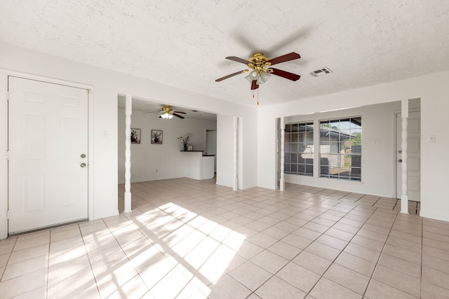 10431 Sagewillow Ln, Houston, TX 77089 - unfurnished living room with ceiling fan, light tile patterned flooring, a textured ceiling, and baseboards