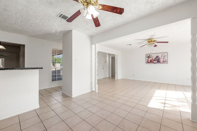 10431 Sagewillow Ln, Houston, TX 77089 - spare room featuring a ceiling fan, light tile patterned floors, a textured ceiling, and baseboards