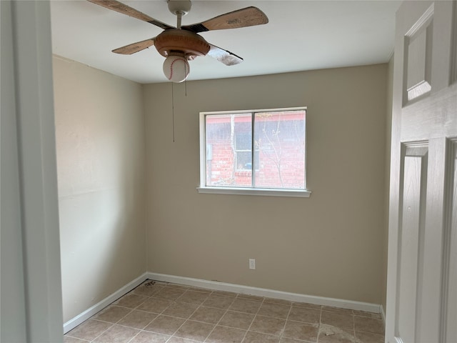spare room with baseboards, a ceiling fan, and light tile patterned flooring
