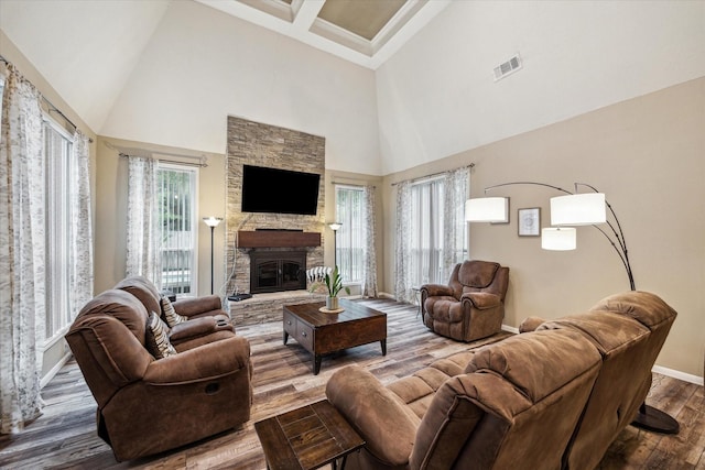11730 Cypresswood Dr, Houston, TX 77070 - living room featuring a high ceiling, baseboards, a fireplace, wood finished floors, and beamed ceiling