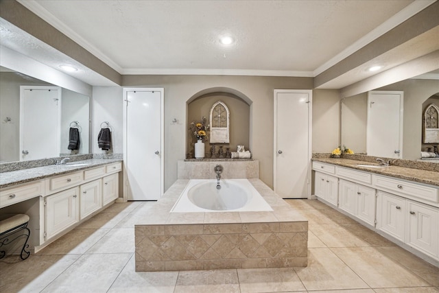 11730 Cypresswood Dr, Houston, TX 77070 - full bathroom with a bath, crown molding, two vanities, recessed lighting, and tile patterned flooring