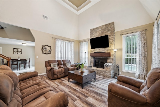 11730 Cypresswood Dr, Houston, TX 77070 - living area featuring high vaulted ceiling, wood finished floors, a fireplace, and baseboards