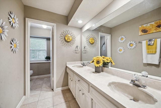 11730 Cypresswood Dr, Houston, TX 77070 - bathroom with toilet, double vanity, baseboards, and tile patterned floors