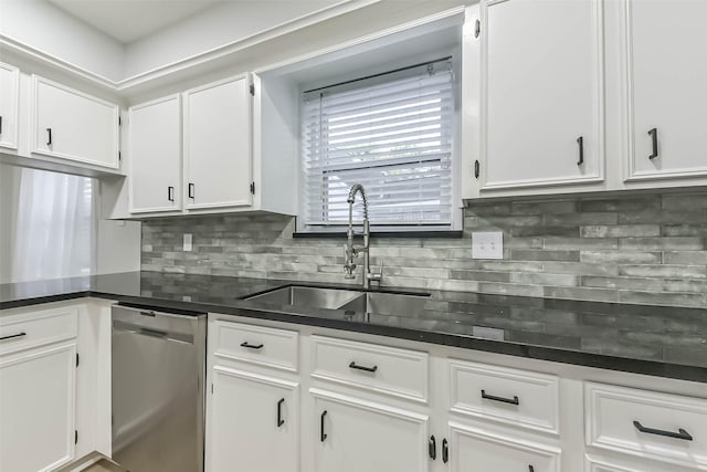 kitchen with dishwasher, a sink, white cabinetry, and dark countertops