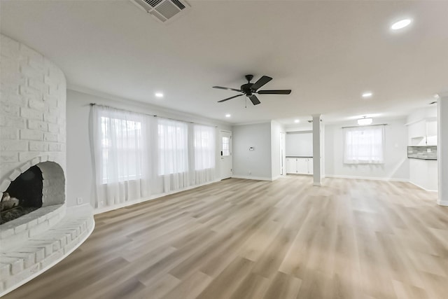 unfurnished living room with a fireplace, recessed lighting, a ceiling fan, light wood-type flooring, and baseboards
