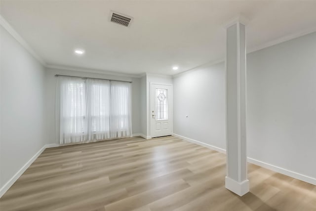 foyer entrance with crown molding, light wood finished floors, baseboards, and recessed lighting