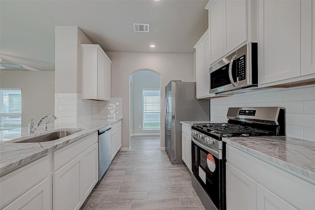 10256 Badger Run Ln, Magnolia, TX 77354 - kitchen with appliances with stainless steel finishes, a sink, healthy amount of natural light, light stone countertops, and recessed lighting