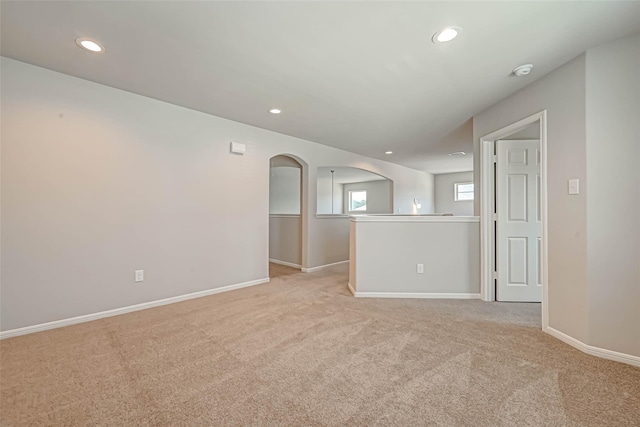 10256 Badger Run Ln, Magnolia, TX 77354 - unfurnished room with arched walkways, light colored carpet, recessed lighting, and baseboards