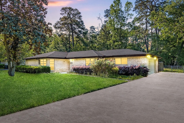view of front of home with brick siding, a garage, and asphalt driveway