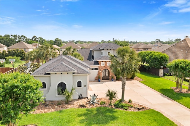 39 New Oak Trl, Humble, TX 77346 - view of front of home with a residential view, stucco siding, concrete driveway, and roof with shingles