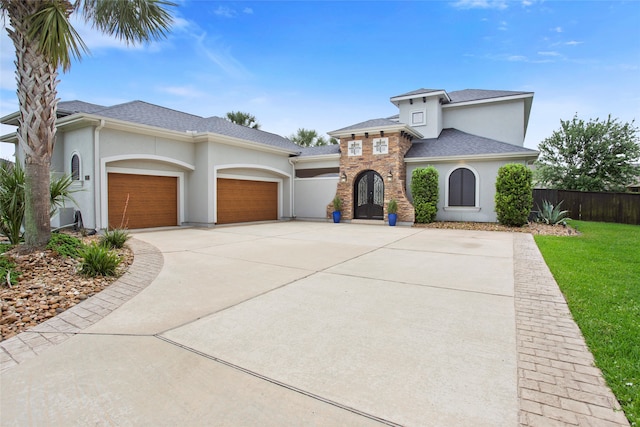 39 New Oak Trl, Humble, TX 77346 - view of front of property with stucco siding, a garage, driveway, and roof with shingles